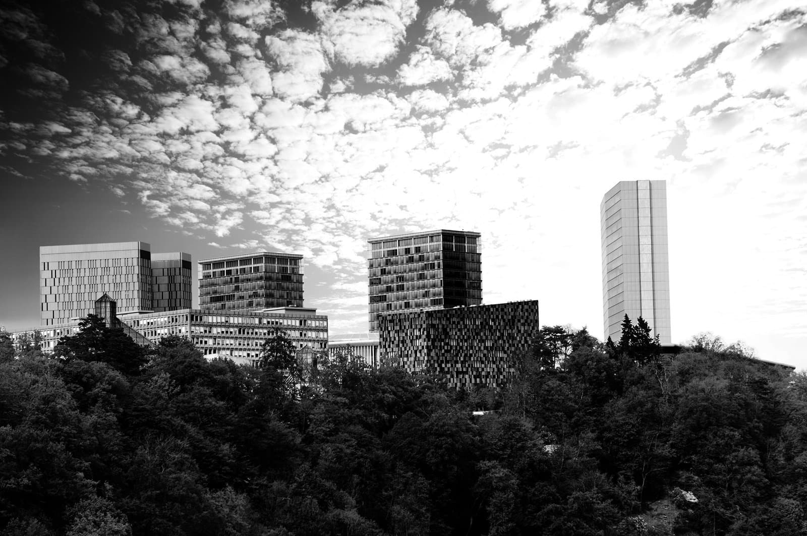 Modern buildings with beautiful sky and clouds in Luxembourg surrounded by forest