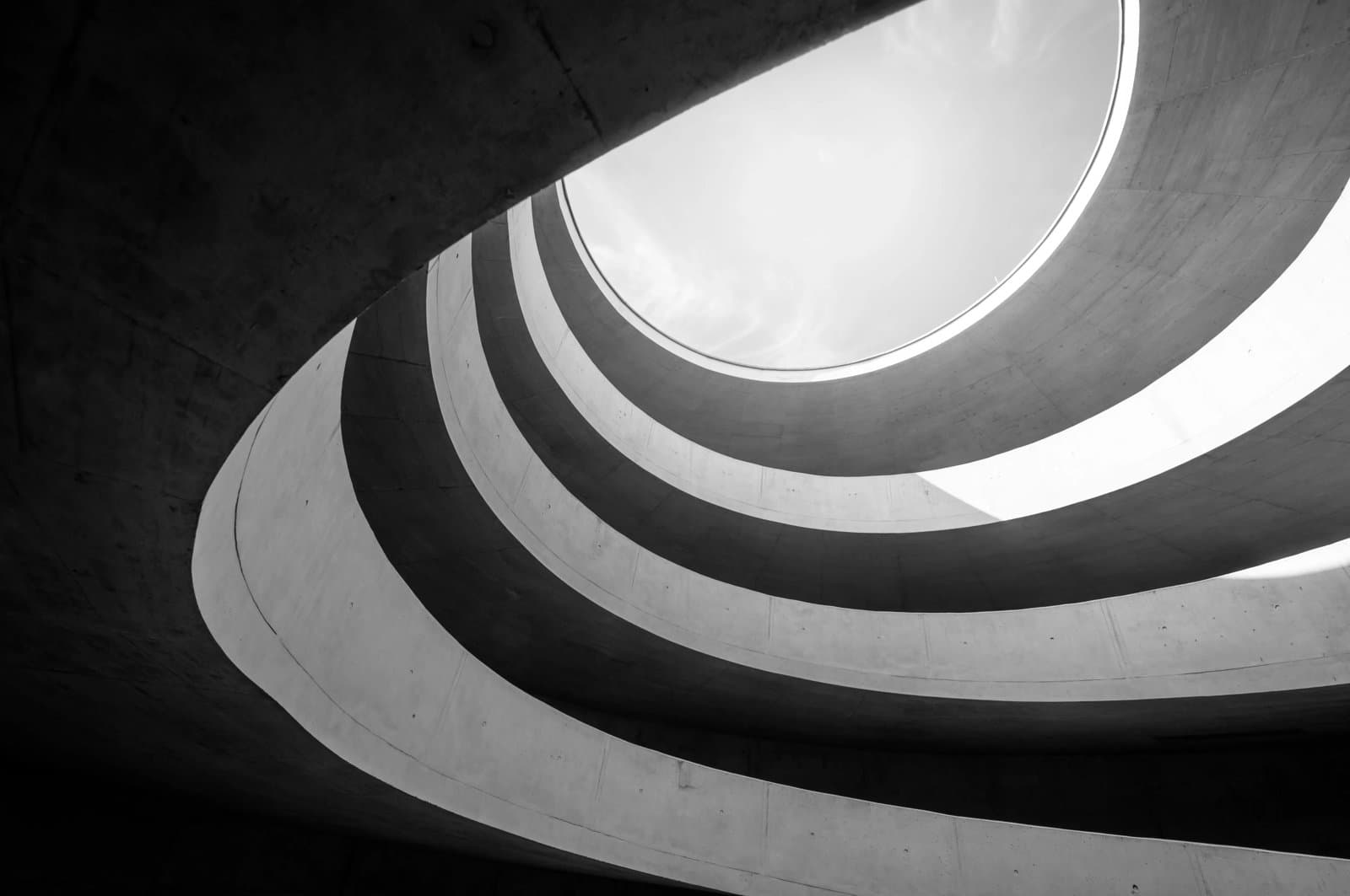 a modern spiral stairway emphasizing its sleek design against a clear sky