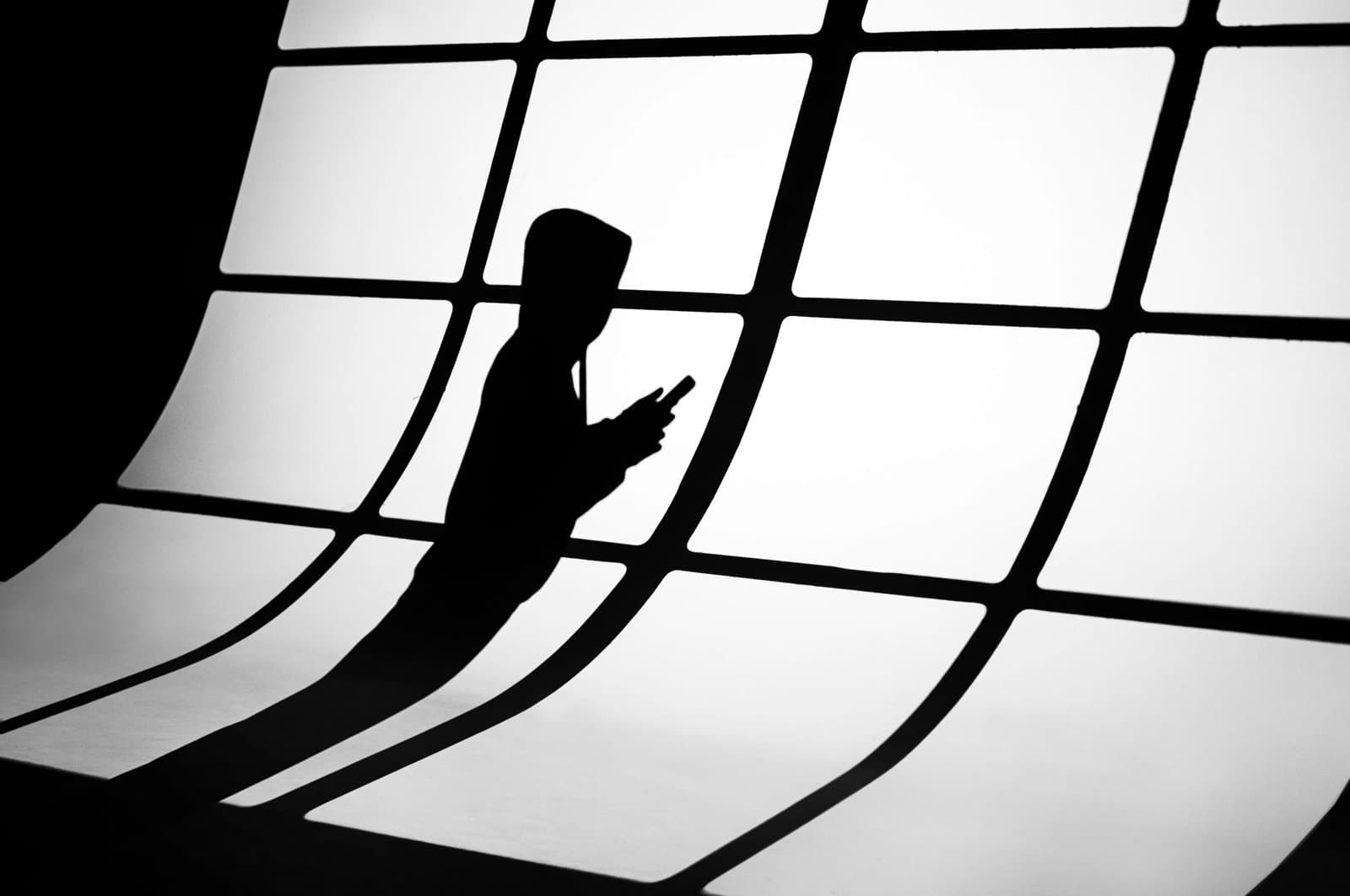 Silhouette of a person using a mobile phone