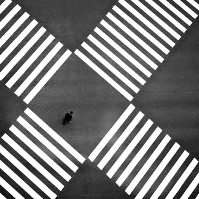Aerial view of single person crossing a big intersection
